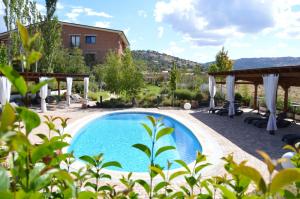 a pool in the backyard of a villa at Los Cinco Enebros Hotel & Spa by Bossh! Hotels in Robledo de Chavela