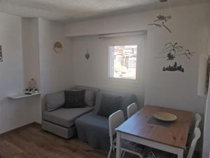 a living room with a couch and a table at Appartamento Aurora - Passo del Tonale in Passo del Tonale