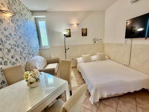 a bedroom with a bed and a table and a couch at Guesthouse Villa Vice in Split
