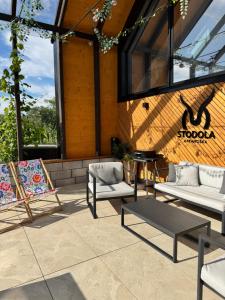 a patio with chairs and a table in front of a building at STODOLA U Františka in Dolní Bojanovice