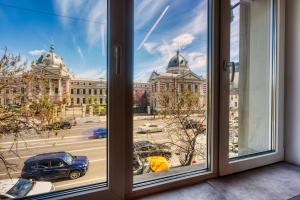 a window with a view of a building at Old Town Apartments Brătianu - City Center Stay in Bucharest