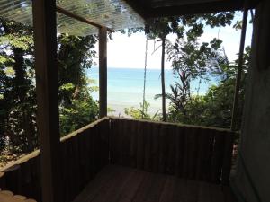 a room with a balcony with a view of the ocean at LookOut DrakeBay in Drake