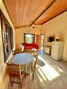 a living room with a table and chairs and a couch at 3 400m Centro de Bombinhas in Bombinhas