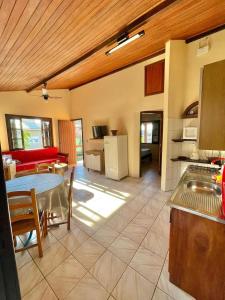 a kitchen and a living room with a table at 3 400m Centro de Bombinhas in Bombinhas
