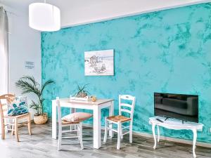 a room with a table and chairs and a tv at Anzio paradise in Anzio