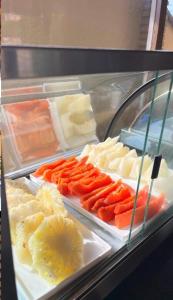 a refrigerator filled with lots of different types of food at Pousada Refugio Jardim de Canoa in Canoa Quebrada