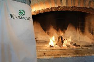 a brick oven with a fire in it at OPG Kuzmanović in Goljak