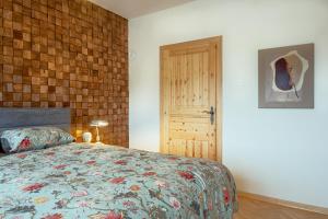 a bedroom with a bed and a wooden door at OPG Kuzmanović in Goljak