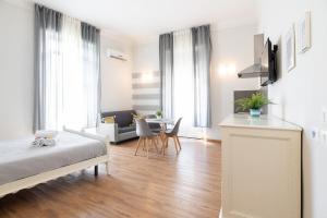 a bedroom with a bed and a living room at Camera Tua - Falloppio 44 Rooms in Padova