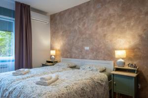 a bedroom with two beds with towels on them at OPG Kuzmanović in Goljak