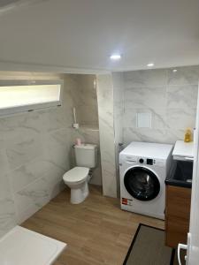 a bathroom with a toilet and a washing machine at Chez Lina in Chartres