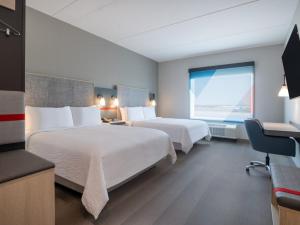 a hotel room with two beds and a window at avid hotel Redding by IHG in Redding +29 photos