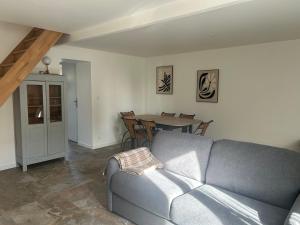 a living room with a couch and a table at La Petite Maison in Toutlemonde +5 photos