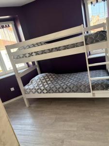 a bedroom with two bunk beds and a window at Chambre Confort 4 personnes in Toul
