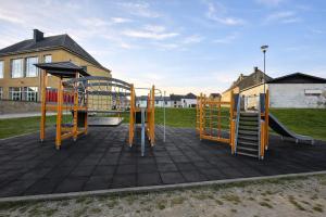 a playground with a slide and a play structure at La Vie En Rose in Muno