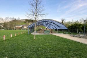 a playground in a park with a blue structure at La Vie En Rose in Muno