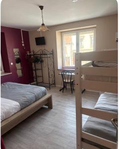 a room with two bunk beds and a table at Chambre Confort 4 personnes in Toul