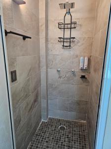 a bathroom with a shower with a glass door at Casa María in Tonatico +11 photos