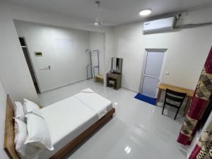 a bedroom with a bed and a tv in it at Athireege in Manadhoo