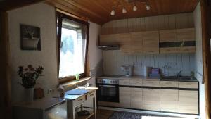 a small kitchen with a stove and a window at Otto`s Ferienwohnung in Biedenkopf