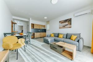 a living room with a couch and a table at ARA Lux Apartments in Utjeha