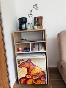 a book shelf with a picture of a dinosaur on it at Cabañas Agroturistica la Polkca - Experiencia Cafetera in Líbano