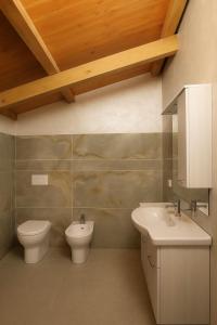a bathroom with a toilet and a sink at Resort Helenia in Caulonia