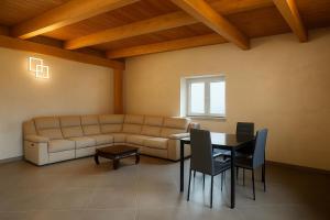 a living room with a couch and a table and chairs at Resort Helenia in Caulonia
