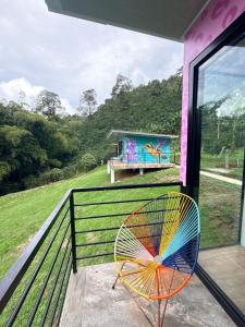 a colorful fan sitting on the balcony of a house at Cabañas Agroturistica la Polkca - Experiencia Cafetera in Líbano
