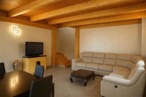 a living room with a couch and a tv at Resort Helenia in Caulonia