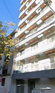 a large white building with balconies on the side of it at Monoambiente con balcón in Buenos Aires