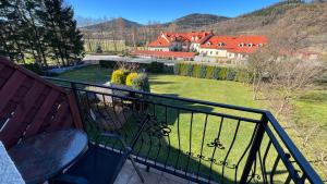 a balcony with a view of a house and a garden at Anmar Pokoje Narty Rowery in Stronie Śląskie +10 photos