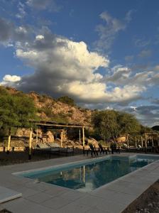 a group of animals walking around a swimming pool at El Chiflon Posta Pueblo in El Chiflón