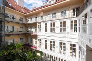 a row of white buildings with balconies at Pertschy Palais Hotel in Vienna