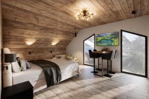 a bedroom with a white bed and a wooden ceiling at ELAFON Lodge in Kolašin