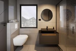 a bathroom with a toilet and a sink and a window at ELAFON Lodge in Kolašin