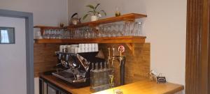 a kitchen counter with glasses on a wooden table at L'auberge du Houx in La Houssière