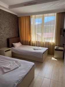 a hotel room with two beds and a window at Vibe Hotel Vanadzor in Vanadzor +52 photos