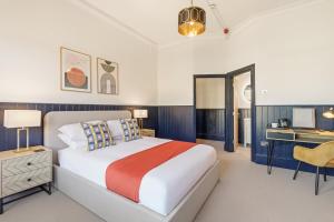 a bedroom with a large bed and a desk at The Jam Jar, Newcastle, Jesmond in Jesmond