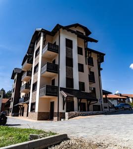 a large apartment building with black and white at Mali Raj in Zlatibor