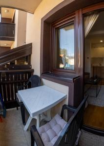 a table and chairs in a room with a window at Mali Raj in Zlatibor +2 photos