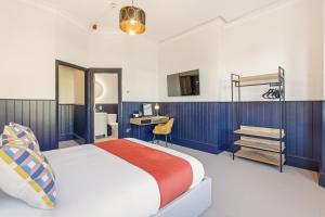 a hotel room with a bed and a desk at The Jam Jar, Newcastle, Jesmond in Jesmond