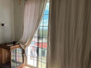 a room with a window with a view of a building at Birdhouse in Guanajuato