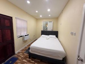 a bedroom with a bed in a room with a window at Very Ralaxing in Saint Georgeʼs