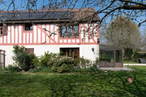 a house with a red and white stripes at La Ronce maison d hote - piscine SPA in Rouvres