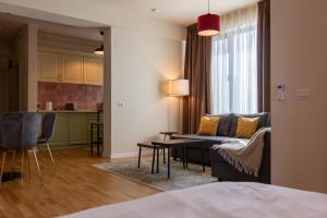 a living room with a couch and a table at Habitat Suites II in Craiova