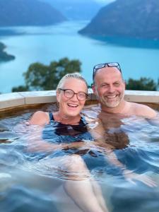 a man and a woman in a swimming pool at Raaum Gard, hytte 3 in Luster