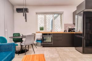 a kitchen with a blue couch and a table at Old Town Apartments Brătianu - City Center Stay in Bucharest
