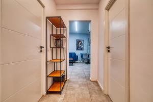 a hallway with a book shelf in a room at Old Town Apartments Brătianu - City Center Stay in Bucharest