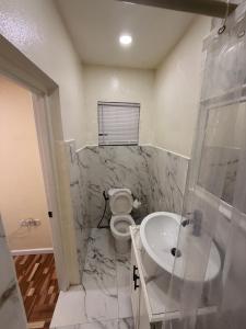a bathroom with a sink and a toilet at Very Ralaxing in Saint Georgeʼs